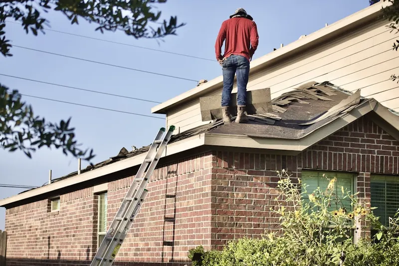 Professional roofer working on a residential roof in Terradyne